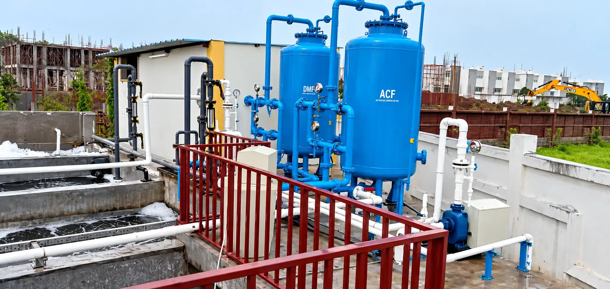 Rooftop water filtration installation with blue treatment vessels and connected pipework